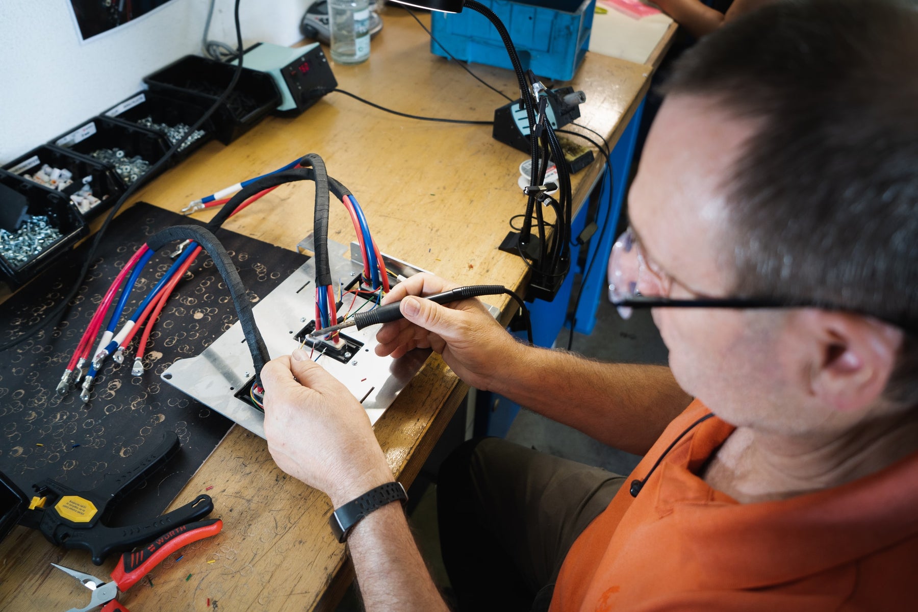 A person doing soldering work on a circuit board