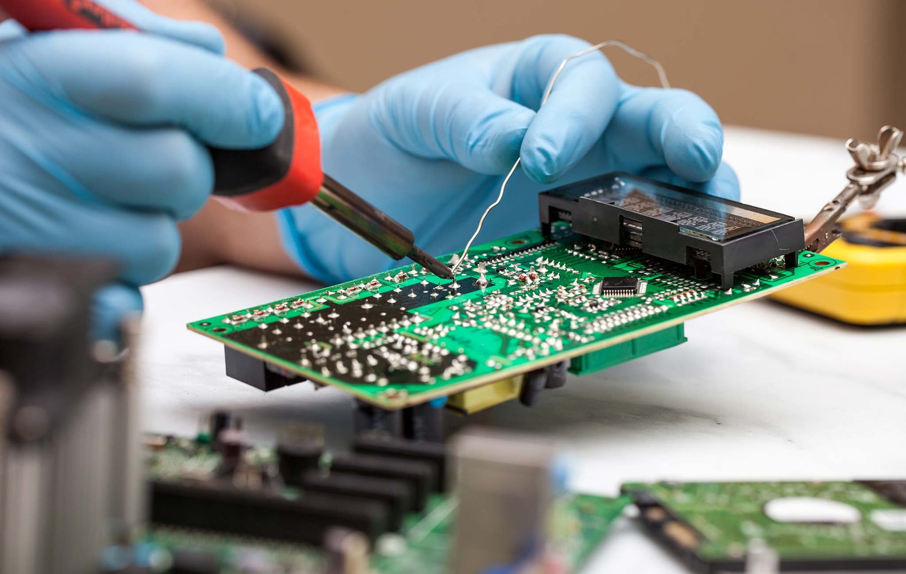 A person soldering circuit board